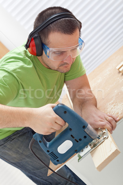 Stock photo: Cutting wood with electric saw