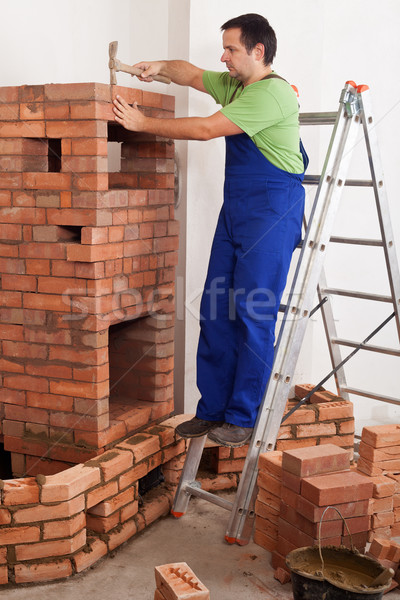 Worker building masonry heater Stock photo © lightkeeper