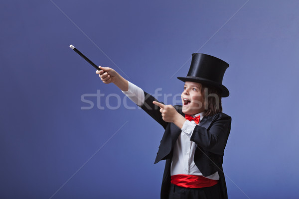 Young magician performing with a magic wand Stock photo © lightkeeper