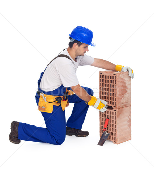 Worker laying bricks - isolated Stock photo © lightkeeper