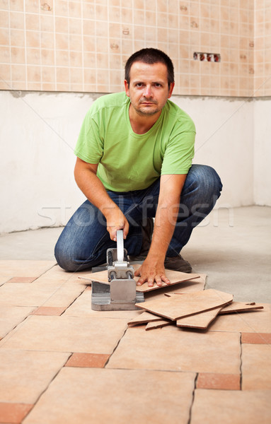 Man cutting ceramic floor tiles Stock photo © lightkeeper
