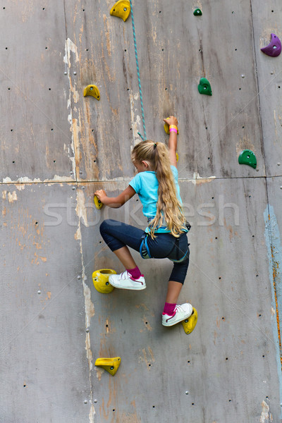 Young girl climbing a wall Stock photo © lightkeeper