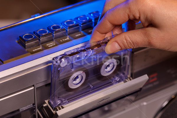 Hand inserts compact audio cassette in retro player - closeup Stock photo © lightkeeper