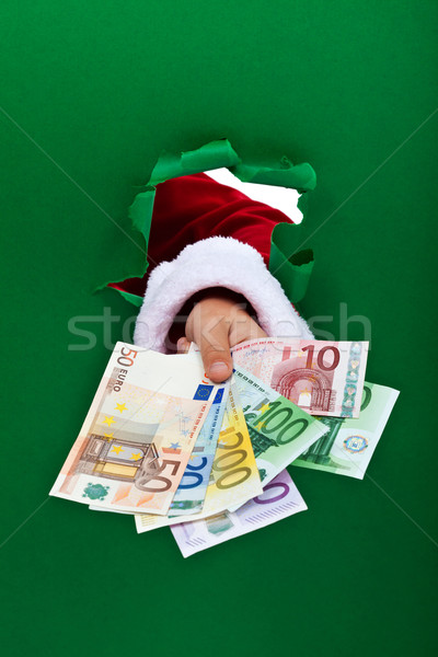 Financing the holidays - euro banknotes handed to you Stock photo © lightkeeper