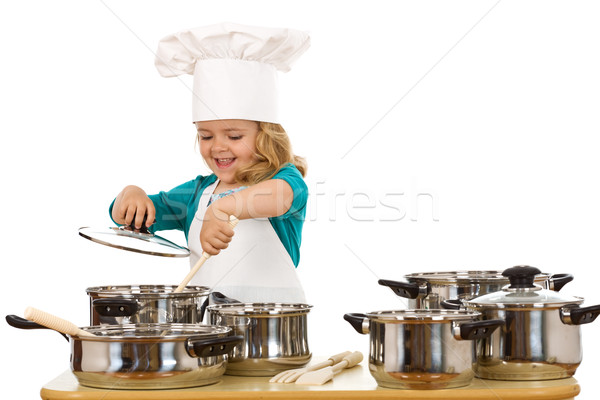 Happy chef girl stirring soup in a bowl Stock photo © lightkeeper