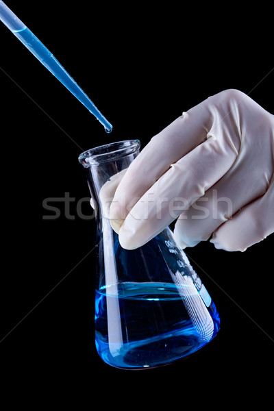 Chemical experiment concept with blue liquid filling Erlenmeyer  Stock photo © lightkeeper