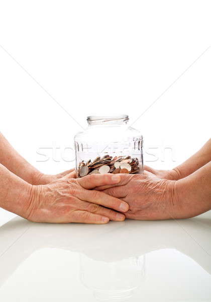 Senior hands holding a jar with coins Stock photo © lightkeeper