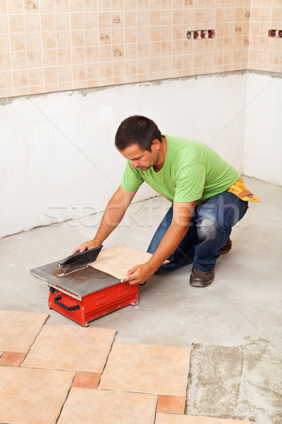 Man cutting ceramic floor tile Stock photo © lightkeeper