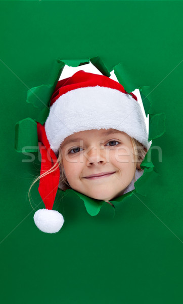 Karácsony lány néz lyuk papír zöld Stock fotó © lightkeeper