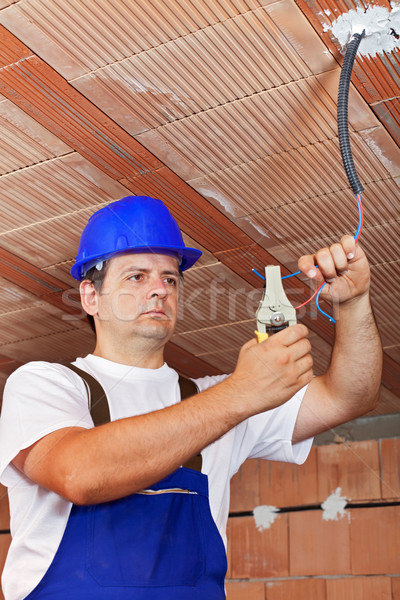 Electrician working with wiring in a new building Stock photo © lightkeeper