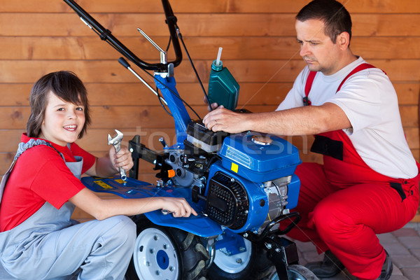 Man and boy preparing a cultivator machine for work Stock photo © lightkeeper