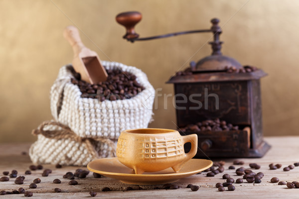 Coffee beans in a bag with grinder and cup Stock photo © lightkeeper