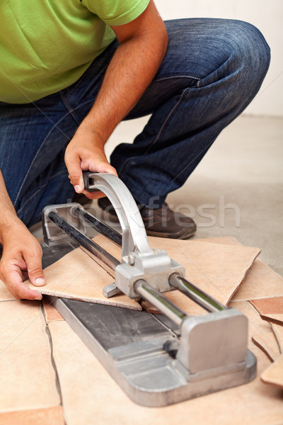 Worker cutting ceramic floor tiles Stock photo © lightkeeper