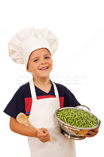 Happy kid with chef hat and a bowl of green peas Stock photo © lightkeeper