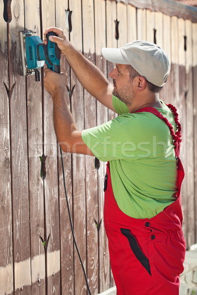 Man renewing a wooden fence Stock photo © lightkeeper