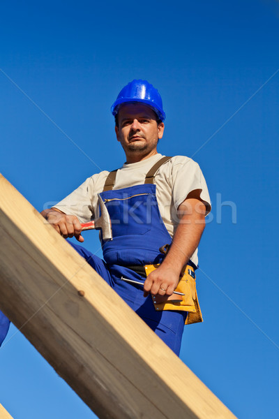 Carpenter worker on top of roof Stock photo © lightkeeper