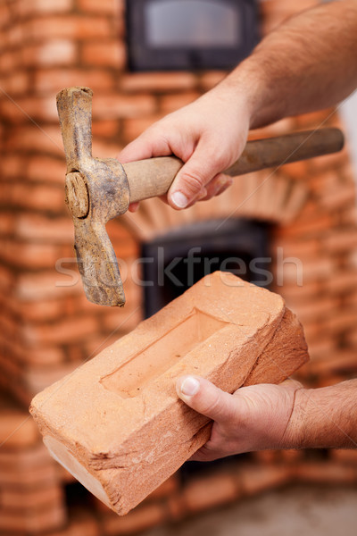 Mason hands with brick and hammer Stock photo © lightkeeper