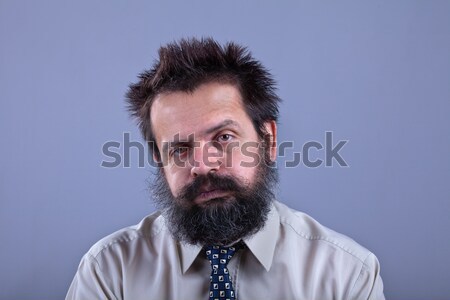 Exhausted man with bushy hair and beard Stock photo © lightkeeper