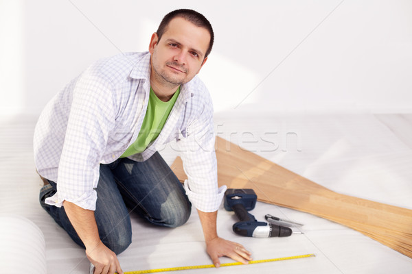 Man preparing to lay some laminate floor planks Stock photo © lightkeeper