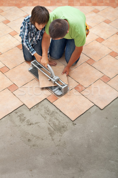 Young boy learning how to cut a ceramic floor tile Stock photo © lightkeeper