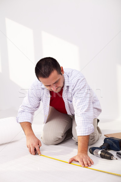Casual man laying isolation foam beneat flooring Stock photo © lightkeeper