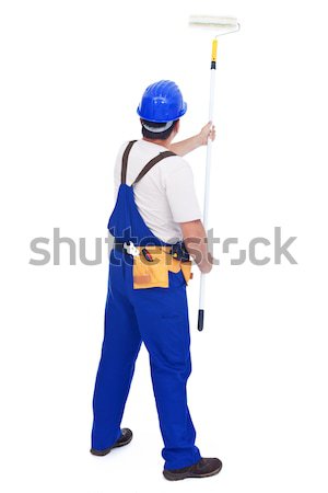 Handyman worker painting the wall with roller brush Stock photo © lightkeeper