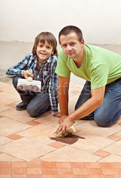 Father and son testing the joint material color on ceramic tiles Stock photo © lightkeeper
