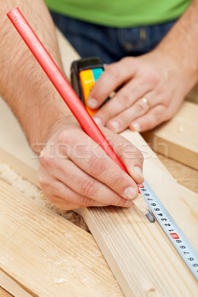 Stock photo: Carpenter or joiner measuring wood