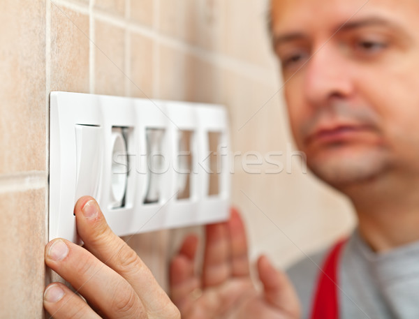 Electrician finished installing electrical wall socket - closeup Stock photo © lightkeeper