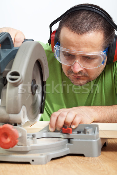 Carpenter worker cutting wood Stock photo © lightkeeper
