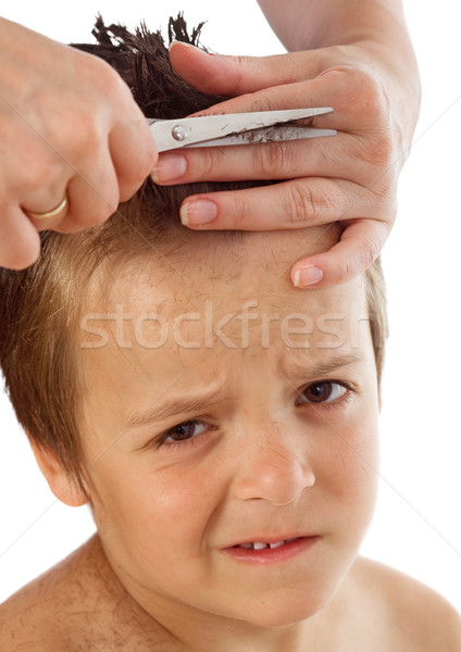 Stock photo: Little boy suffering during his haircut