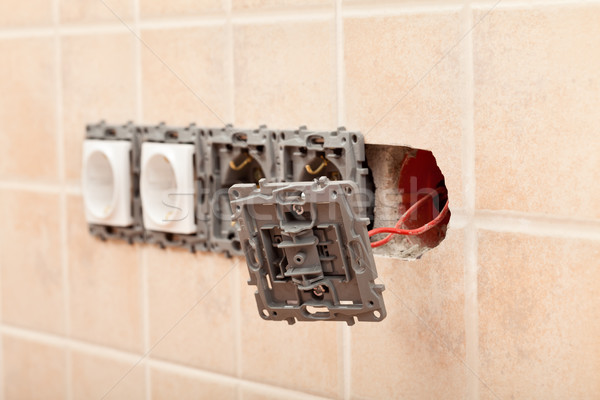 Stock photo: Closeup of a partially installed electrical wall socket