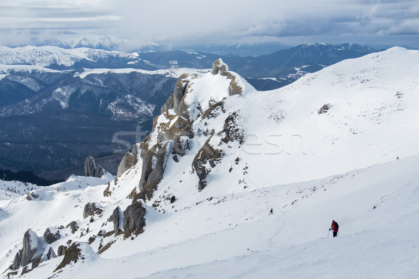 Lonely hiker descending snowy mountain slope Stock photo © lightkeeper