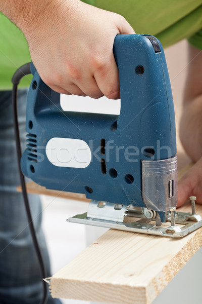 Carpenter or joiner working with electric saw Stock photo © lightkeeper