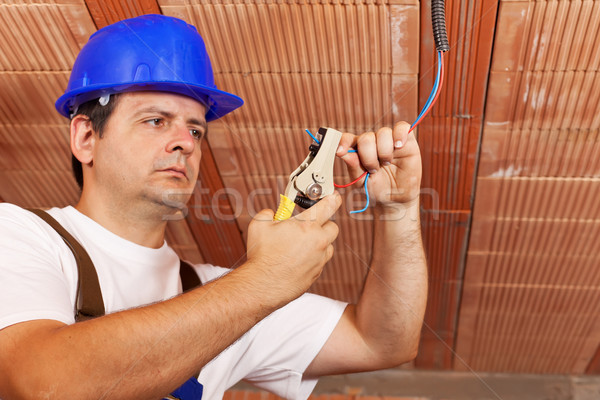 Stock photo: Worker installing electical wiring