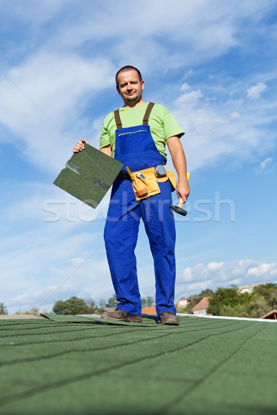 Worker installing bitumen roof shingles Stock photo © lightkeeper