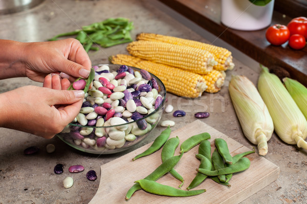 Stock photo: Woman hands shelling colorful fresh beans