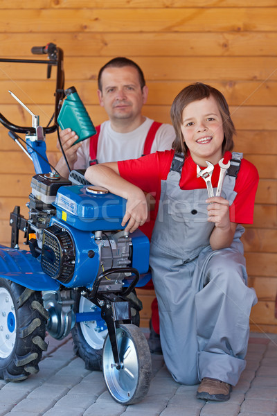 Man and young boy servicing a small tiller machine Stock photo © lightkeeper
