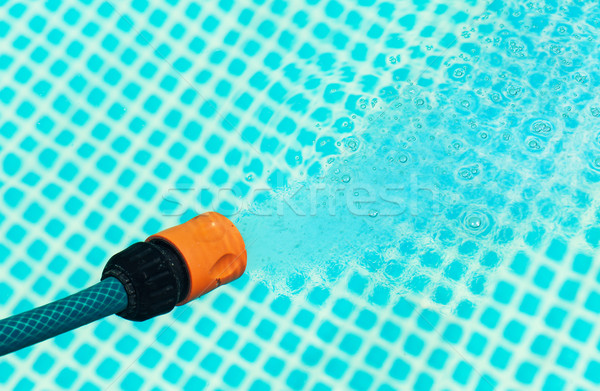 High pressure water from a hose flowing into a pool - closeup Stock photo © lightkeeper