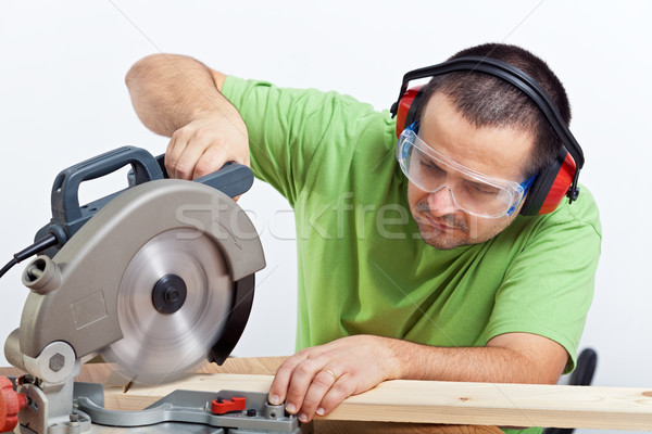 Carpenter cutting wooden plank Stock photo © lightkeeper