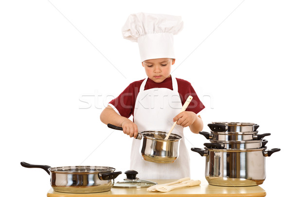 Serious kid chef checking the food Stock photo © lightkeeper