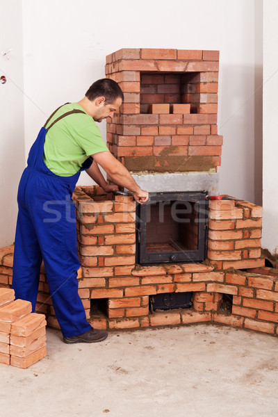 Worker mounting door to a masonry heater Stock photo © lightkeeper