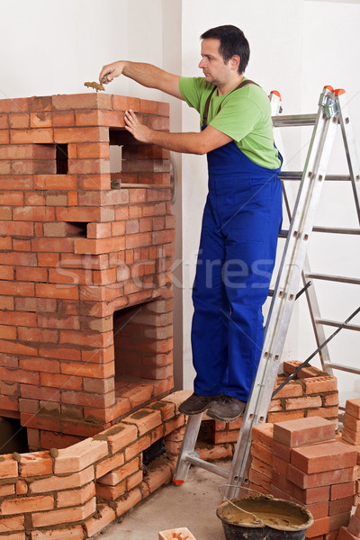 Worker building masonry heater Stock photo © lightkeeper
