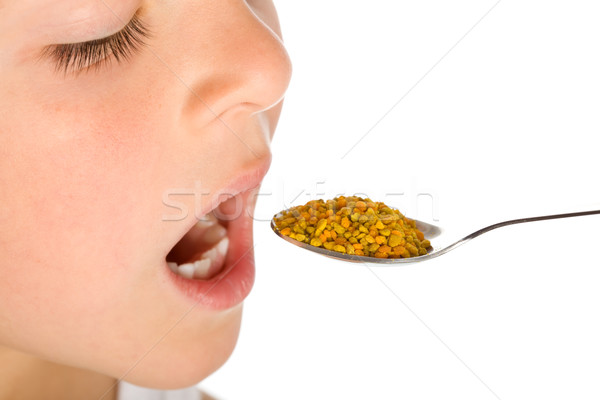 Little boy taking a spoonful of pollen - traditional remedies Stock photo © lightkeeper