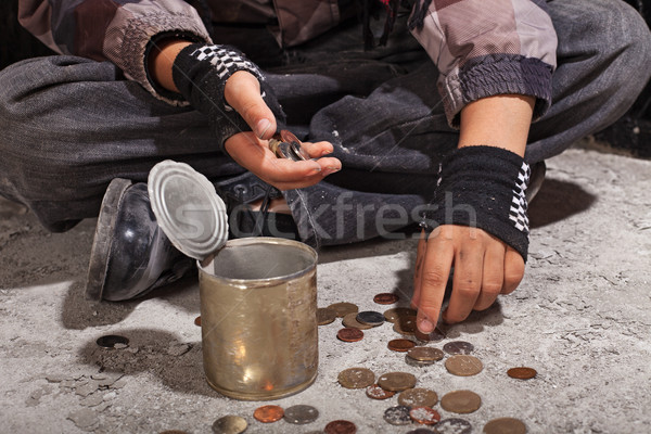 Beggar child counting coins sitting on damaged concrete floor Stock photo © lightkeeper