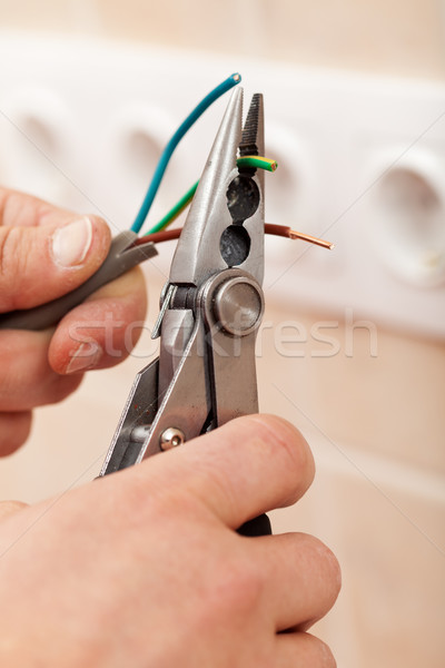 Electrician hands with pliers and wires Stock photo © lightkeeper