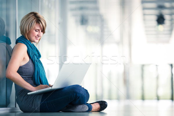 Pretty female student with a laptop computer on university campus Stock photo © lightpoet