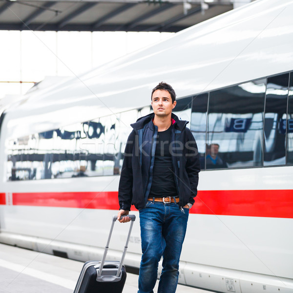 Just arrived: handsome young man walking along a platform  Stock photo © lightpoet