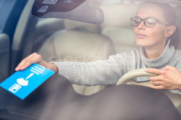 Pretty, young woman driving her new car - putting the necessary  Stock photo © lightpoet