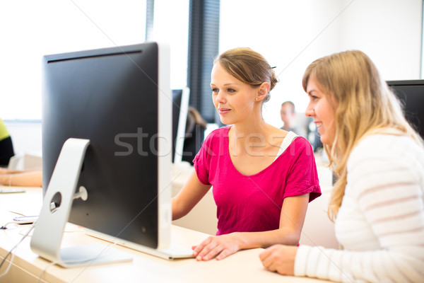 Two female universtiy/college students working on a desktop comp Stock photo © lightpoet